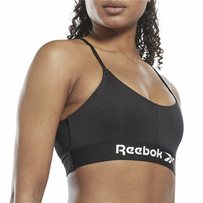 "Närbild fram på Reebok Workout Ready svart sport-bh – Speedwick-material och stödjande resår."